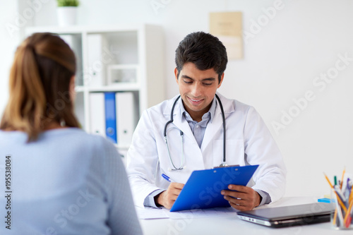 doctor with clipboard and patient at hospital