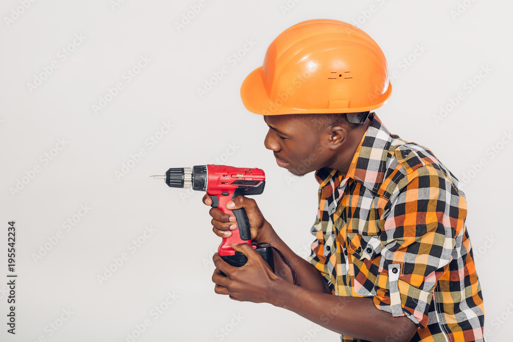 African American worker uses electric screwdriver African American worker uses electric screwdriver