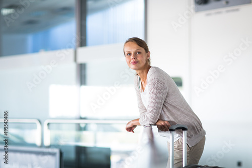 Young female passenger at the airport, about to check-in Free Download Young female passenger at the airport, about to check-in - GFXLoad