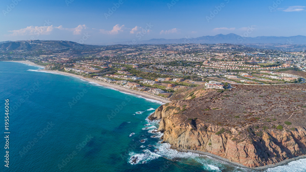 Aerial view of the California coastline in Orange County on a sunny day.