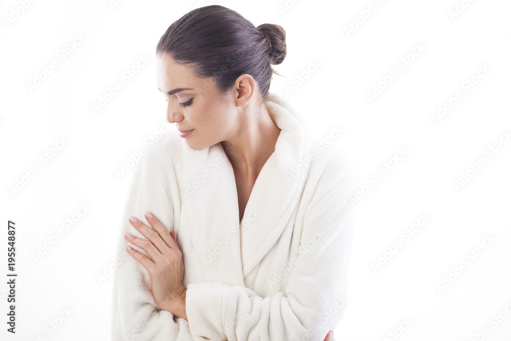 Beautiful and natural woman in white bathrobe is touching her skin. Relax and comfortable feelings only. Beautiful and natural woman in white bathrobe is touching her skin. Relax and comfortable feelings only.