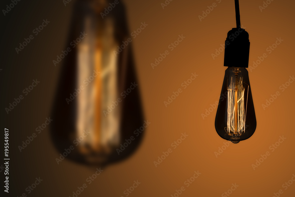 Vintage hanging Edison lights bulbs over dark background