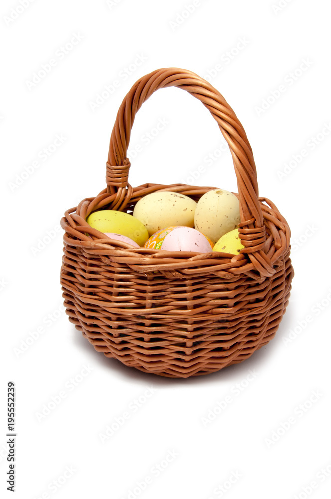 Easter eggs in the basket on white background