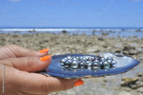 Pacific Islander woman holds Tahitian Black Pearls
