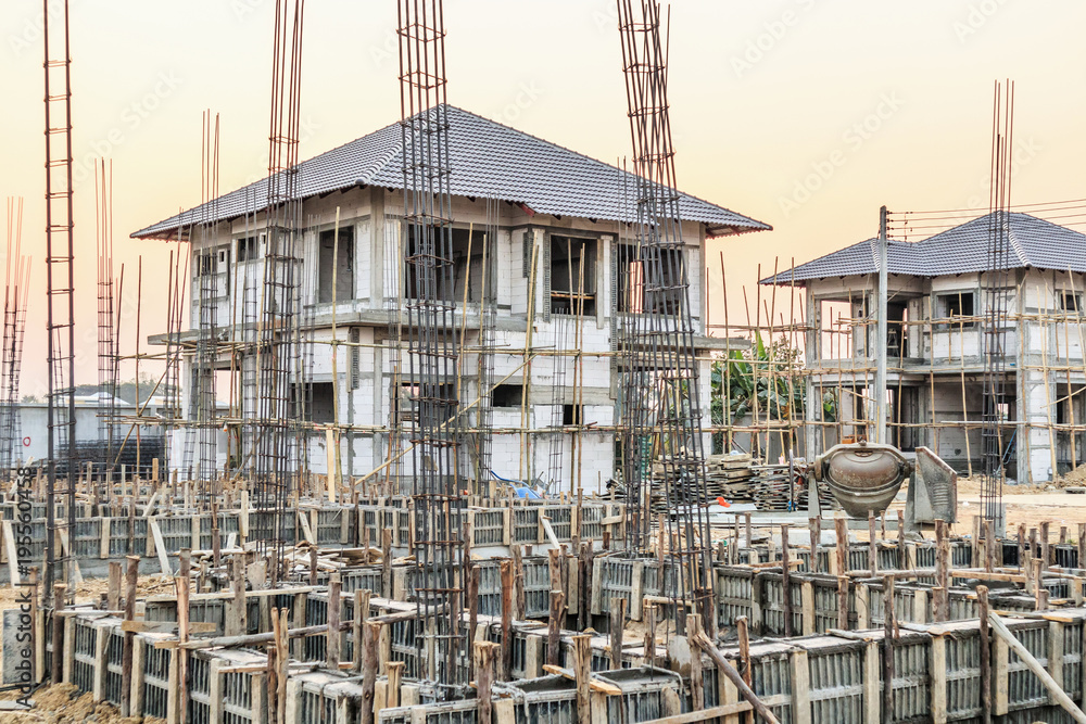 New house under construction at building site New house under construction at building site