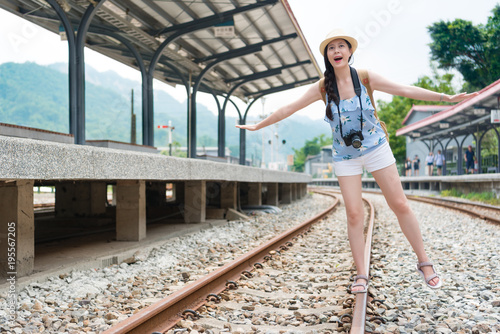 Girl having fun balancing on a railway