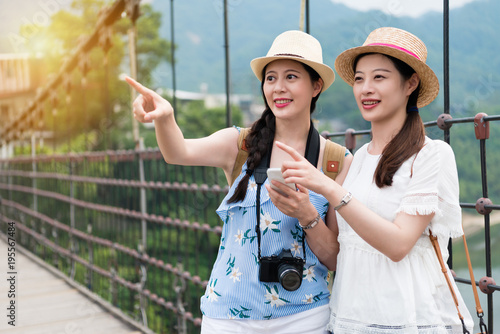 Women on the bridge enjoy the scenery photo