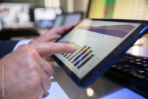 Businessperson Looking At Financial Graph On Digital Tablet