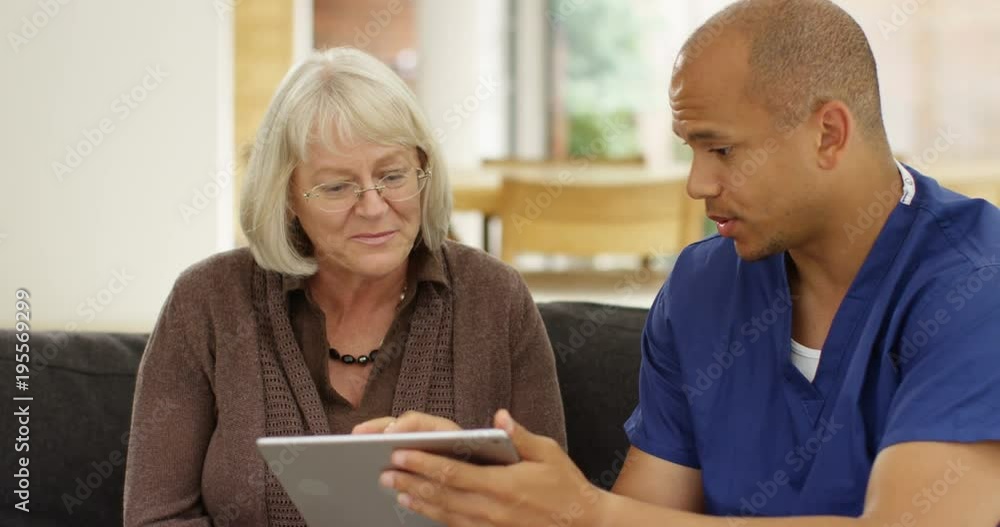 4k, Doctor showing a senior patient some information on a digital tablet in his office. Slow motion 4k, Doctor showing a senior patient some information on a digital tablet in his office. Slow motion