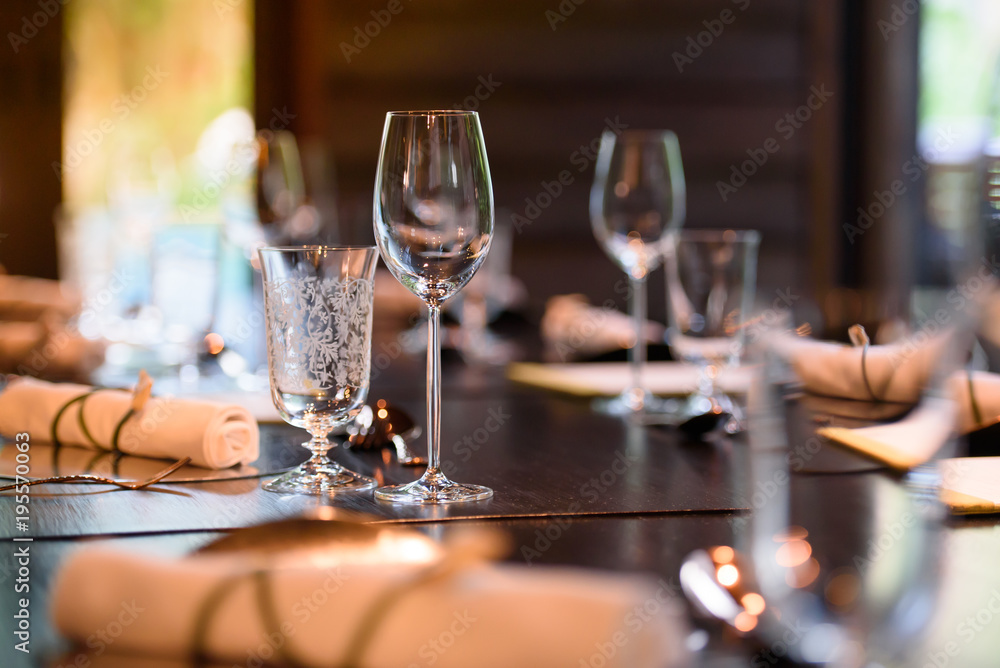 A glass of wine is placed on the dinner table.