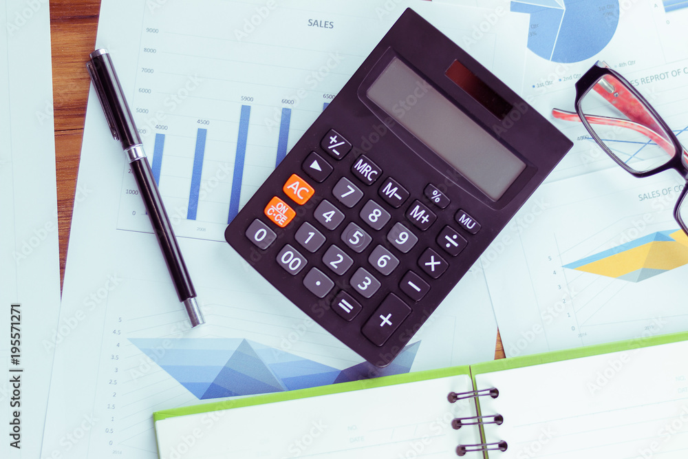 Top view of the businessman's work, calculator placed on the table. Top view of the businessman's work, calculator placed on the table.