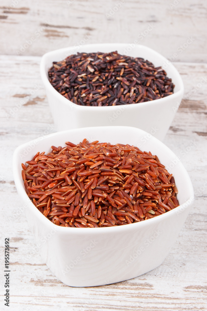 Red and black rice in glass bowls, healthy nutrition concept Red and black rice in glass bowls, healthy nutrition concept