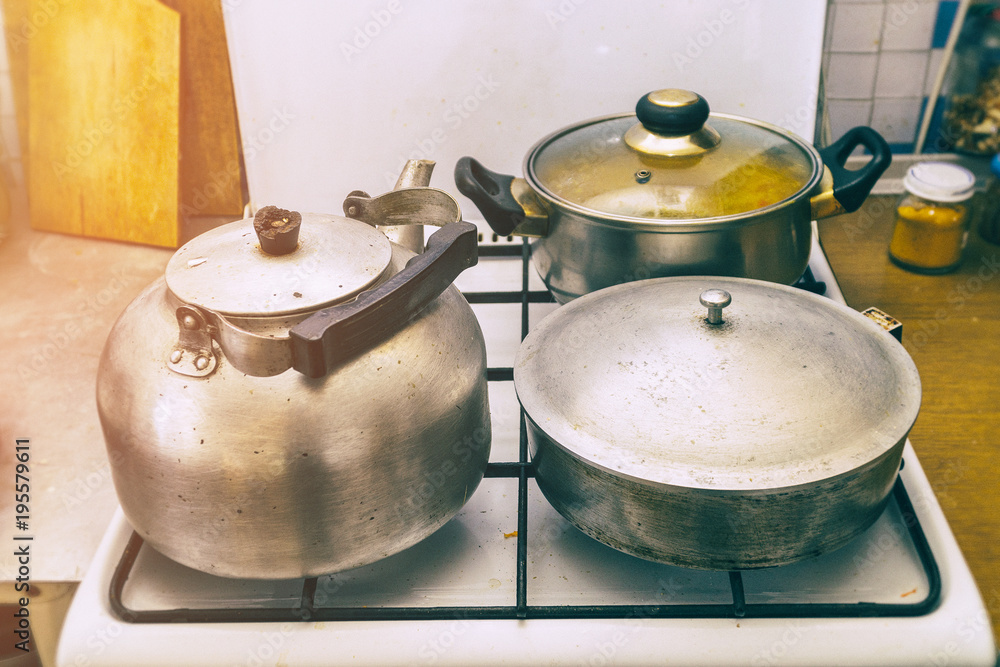 Pan, frying pan and kettle on the stove in the kitchen Pan, frying pan and kettle on the stove in the kitchen