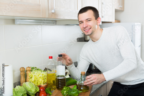 Male with olive oil bottle