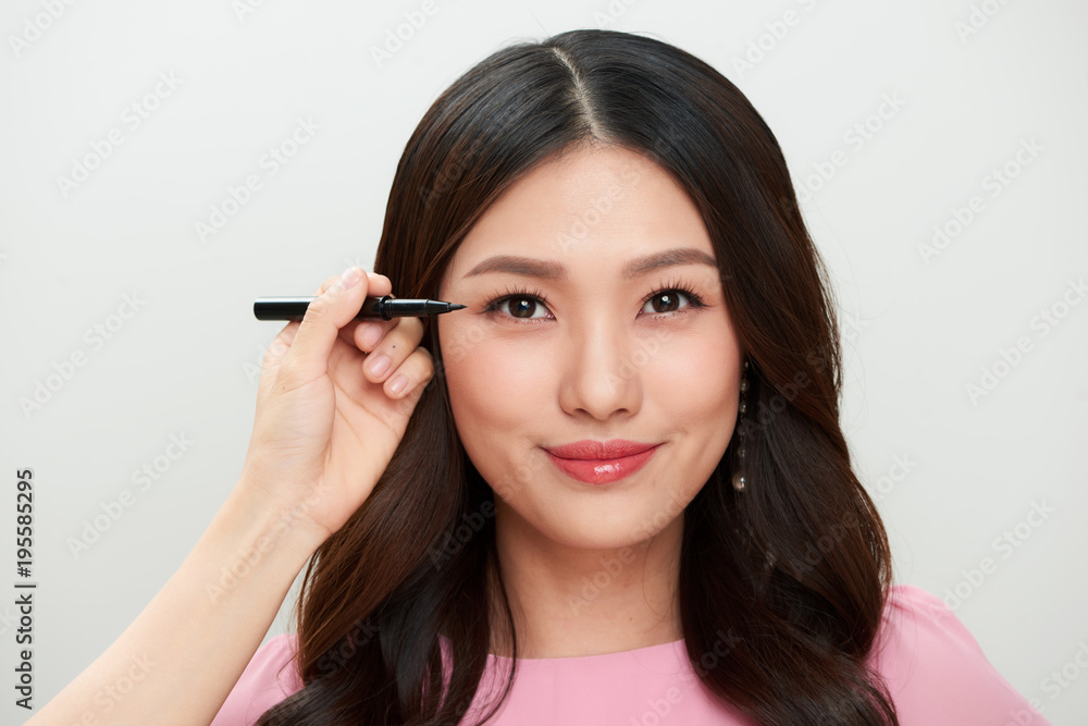 Beautiful young asian woman make-up with black eyeliner.