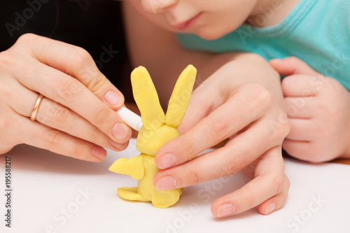 The child is playing with plasticine