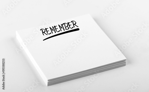 Concept of note with the word Remember written on white paper. Mockup.