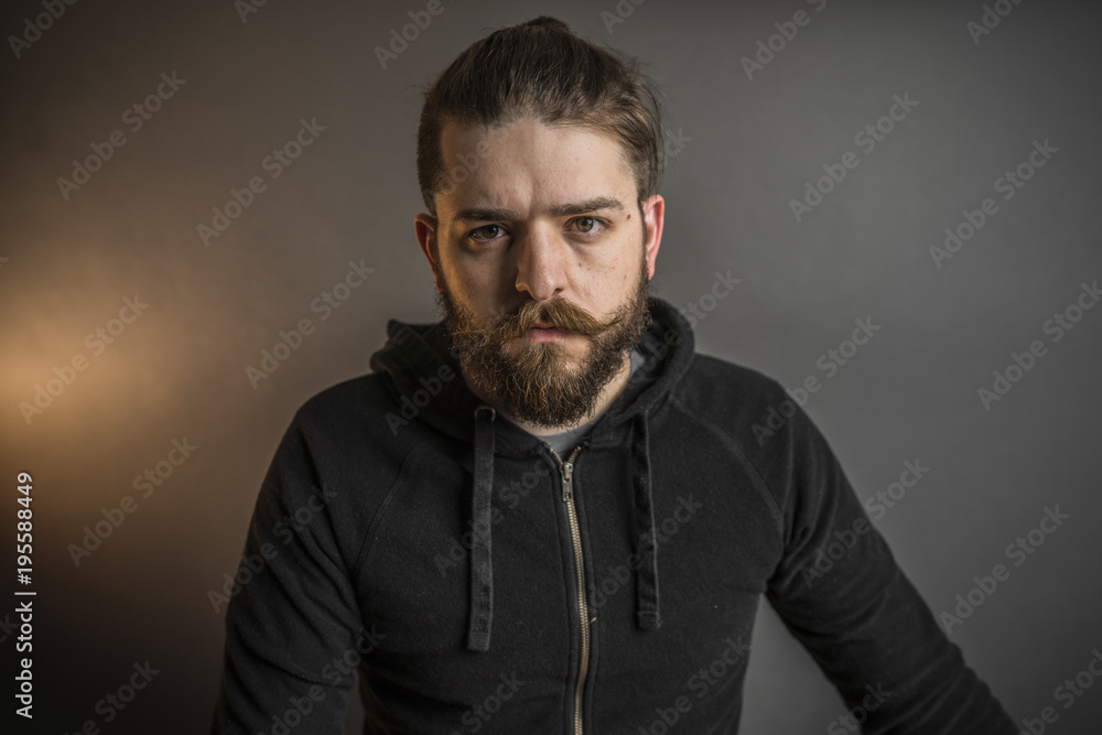 Obraz premium Portrait of a bearded man in a black sweatshirt