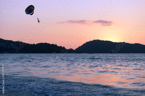 Parachute over the sea at sunset