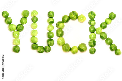 The word 'yuck' is spelled with brussel sprouts to provide a light hearted way of displaying people's opinions towards them and green vegetables in general