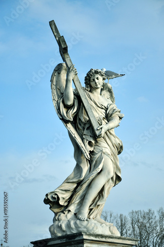 Statue of angel with holy cross
