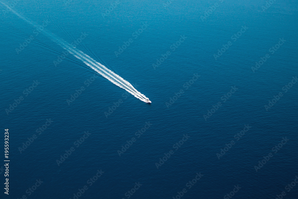 Aerial view of small boat flowing in Mediterranean sea, travel and vacation concept Aerial view of small boat flowing in Mediterranean sea, travel and vacation concept