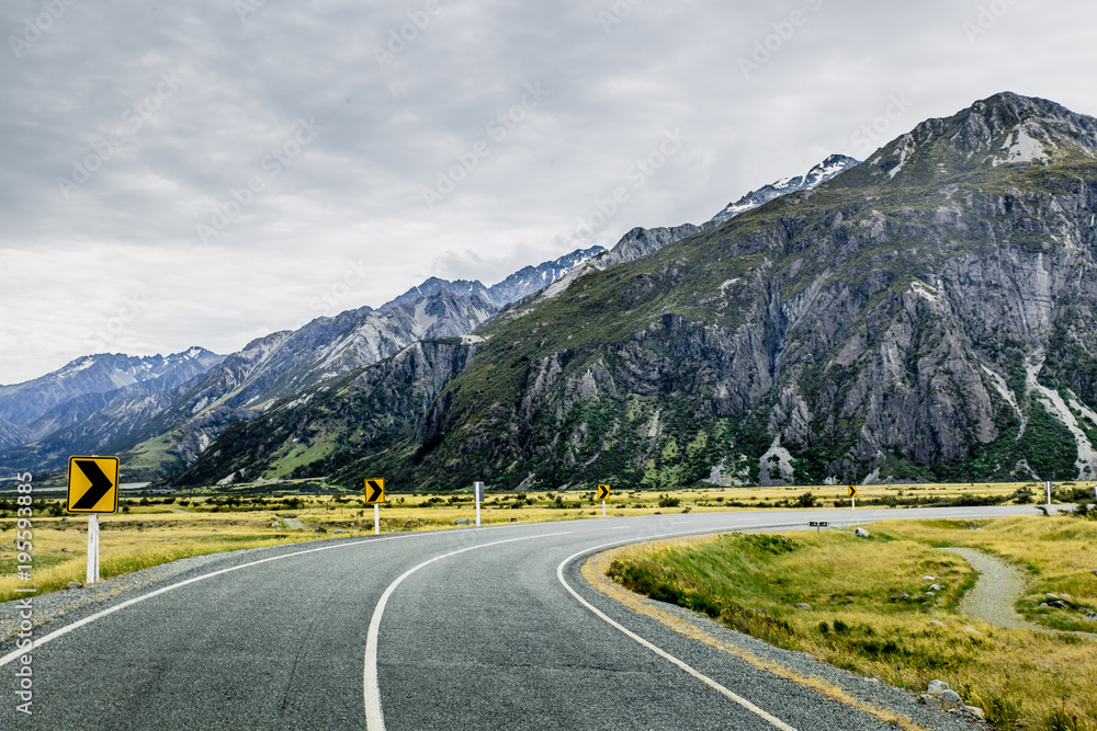 Road between rocky mountains in Mount Cook National Park, New Zealand