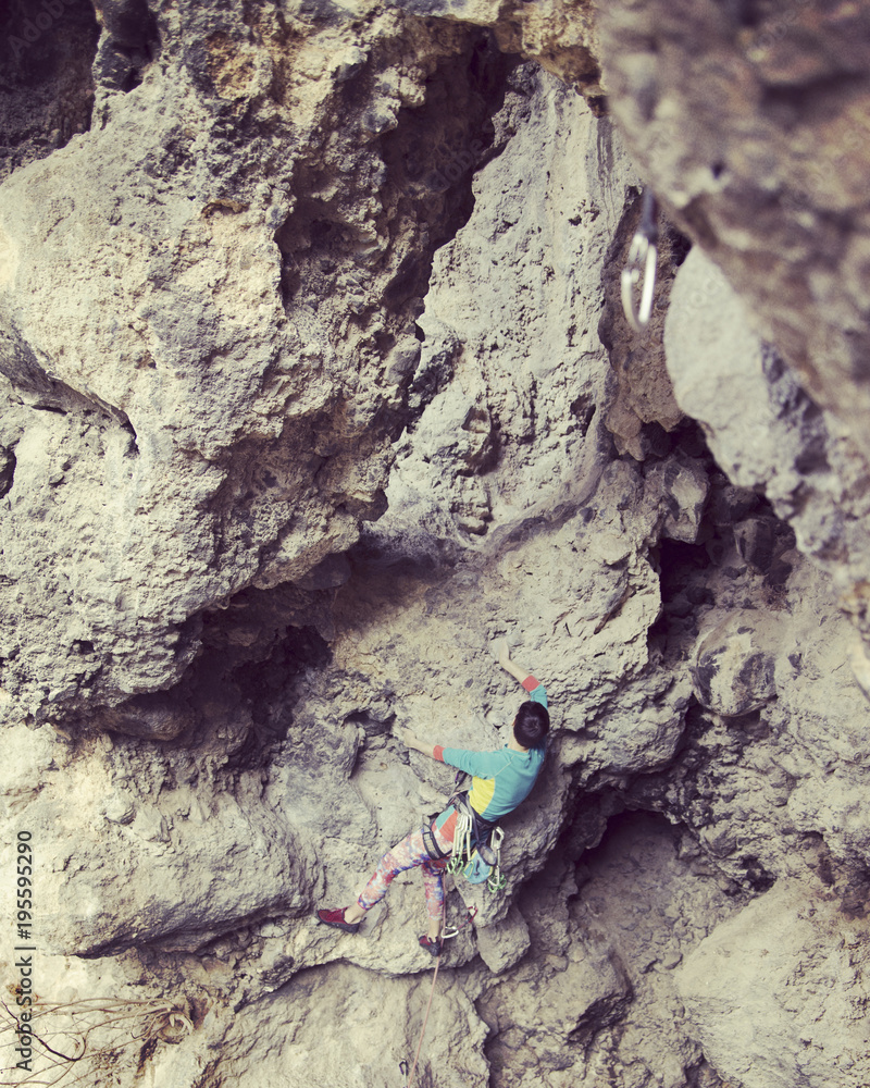 Rock-climbing in Turkey. The climber climbs on the route. Photo from the top. Rock-climbing in Turkey. The climber climbs on the route. Photo from the top.