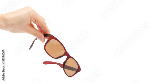 female hand takes or gives sunglasses. Isolated on white background. copy space, template.