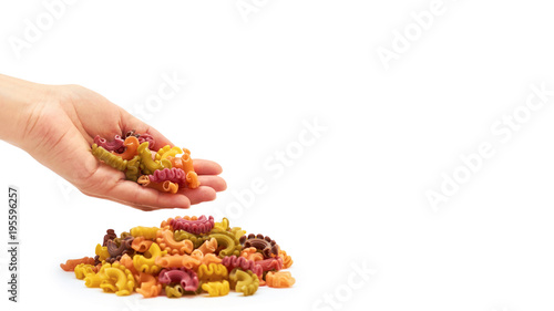 Female hand holds raw colored macaroni. Isolated on white background. copy space, template