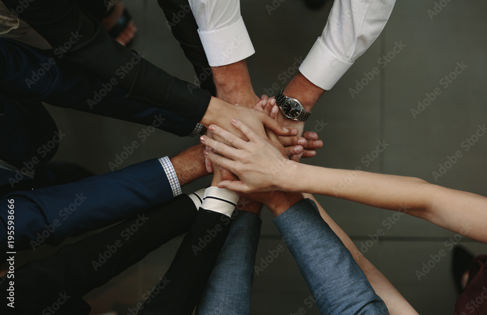Business people showing unity Business people showing unity