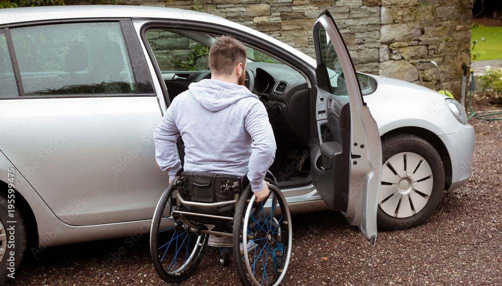 Disabled man boarding in his car Disabled man boarding in his car
