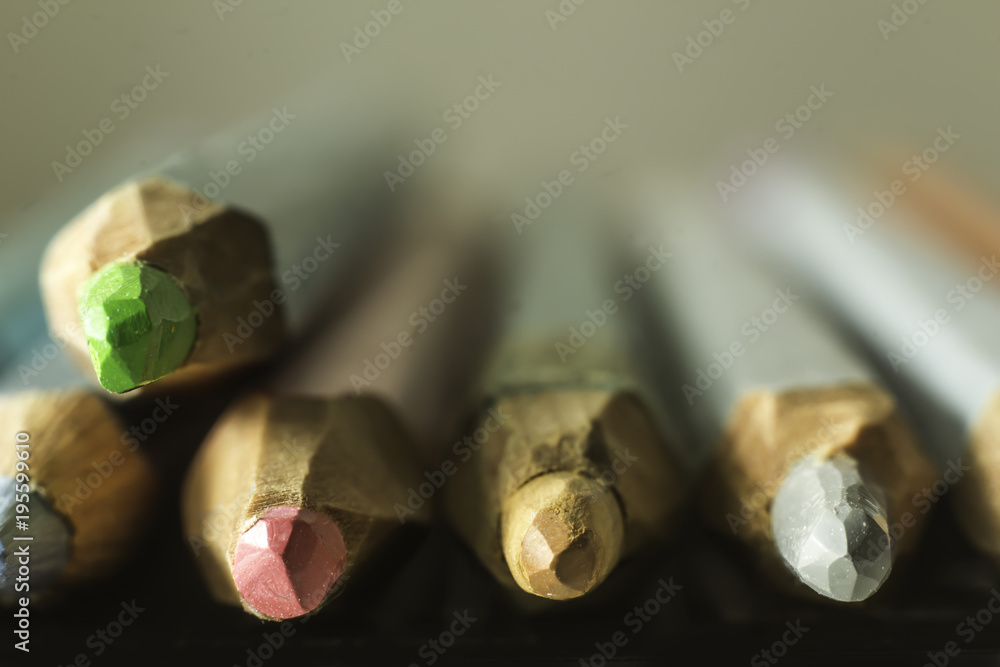 Macro photography of colored pencils. Blurred perspective. Mechanical sharpening of pencils. Photo for the site about art, hobbies, education. Macro photography of colored pencils. Blurred perspective. Mechanical sharpening of pencils. Photo for the site about art, hobbies, education.