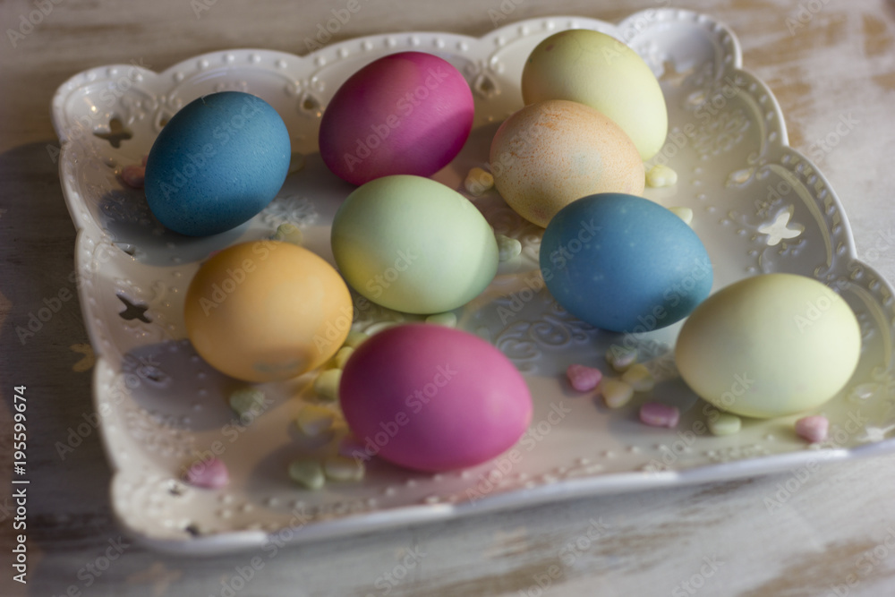 colorful easter eggs on a plate and a dark wooden background colorful easter eggs on a plate and a dark wooden background