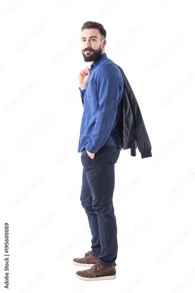 Profile view of happy confident man carrying jacket over the shoulder looking at camera. Full body length portrait isolated on white background. Profile view of happy confident man carrying jacket over the shoulder looking at camera. Full body length portrait isolated on white background.