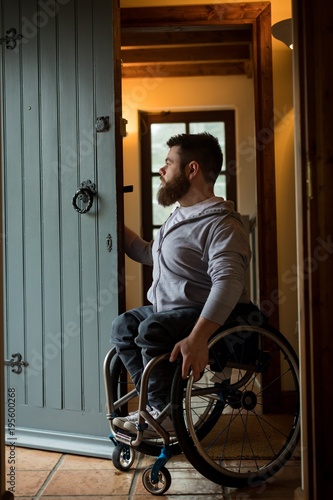 Disabled man closing the door photo