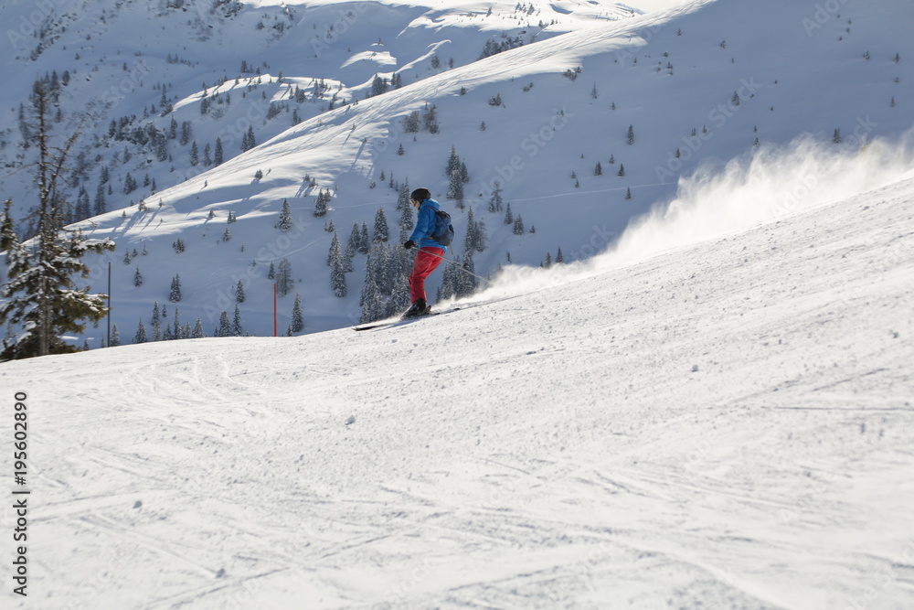 Man skiing down the alpine slope. Ski slope in winter sunny day at the mountain ski resort of Alpbachtal, Wildschönau, Austria