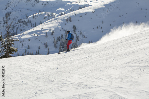 Man skiing down the alpine slope. Ski slope in winter sunny day at the mountain ski resort of Alpbachtal, Wildschönau, Austria