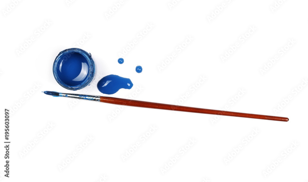 Obraz premium Spilled blue watercolor with bottle and paintbrush isolated on white background, top view