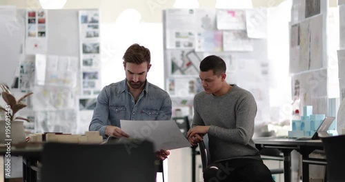 Designers looking at architectural plans in a creative workspace