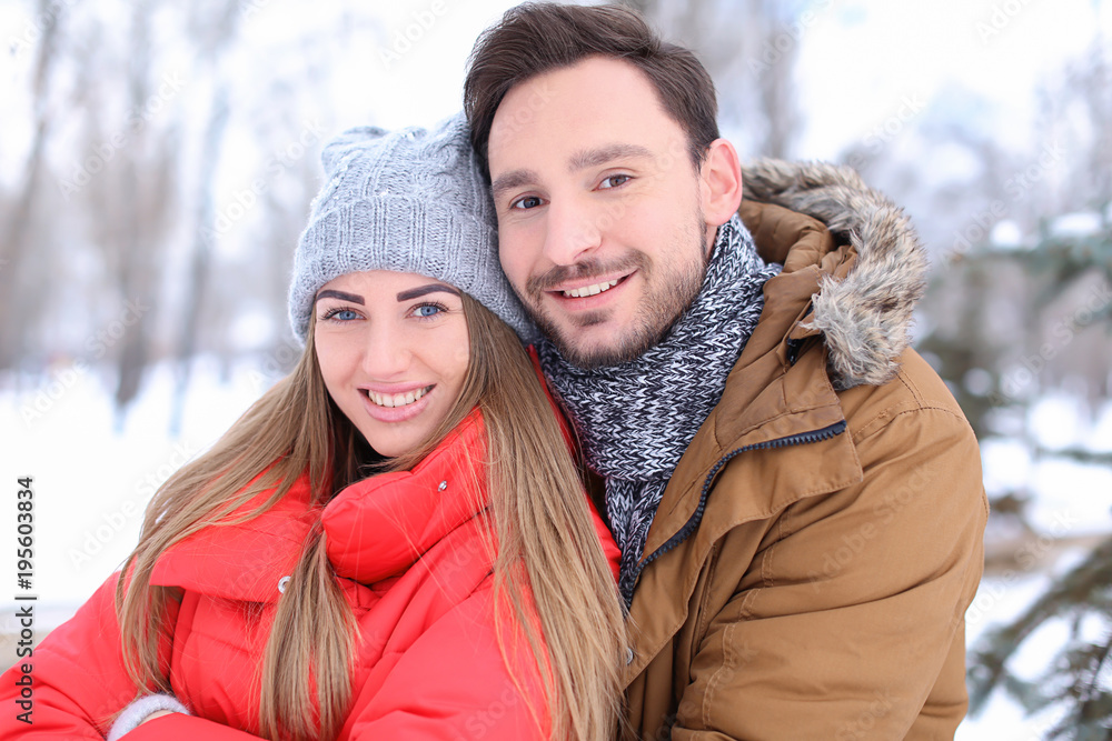 Young couple in park on winter vacation