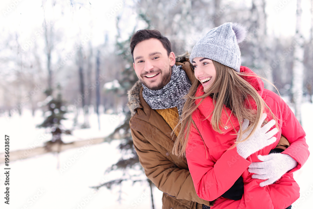 Young couple in snowy park on winter vacation
