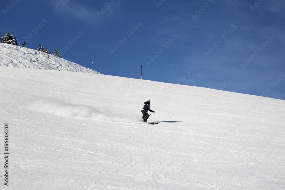 Young woman extremely skiing down the hills at the tyrolean/tirolean Alps.