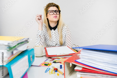 Business woman in office working and thinking