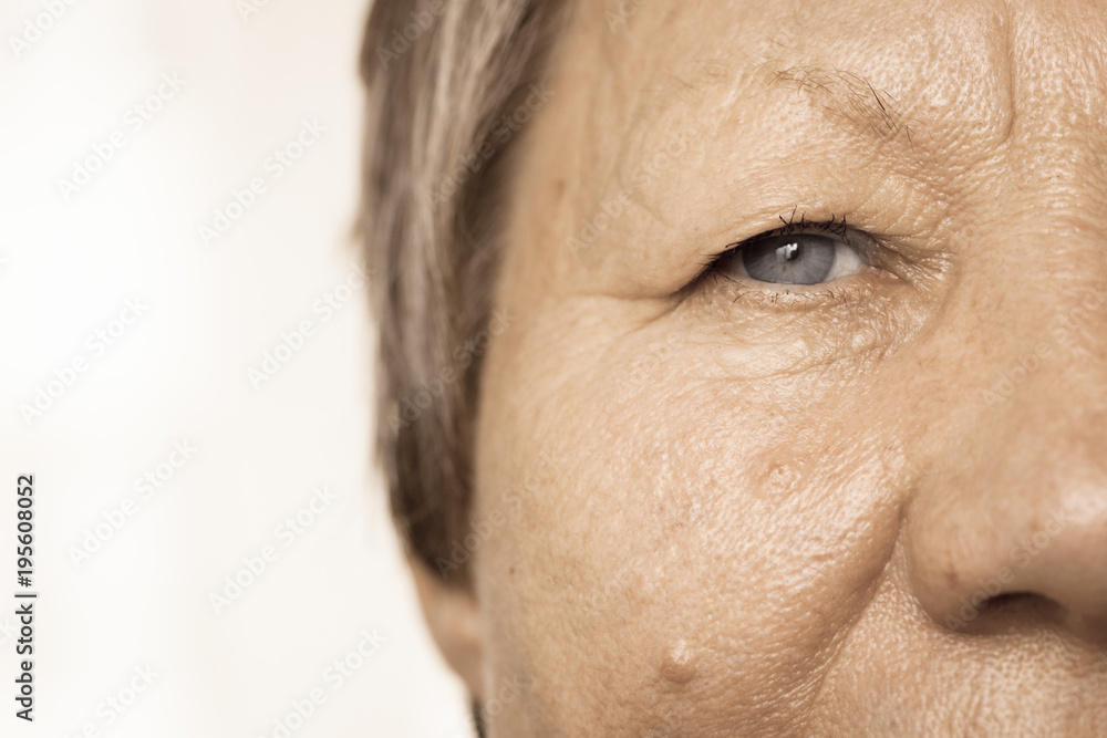 Elderly pensioner female half face portrait closeup Elderly pensioner female half face portrait closeup