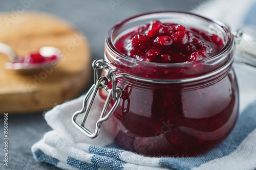 Traditional scandinavian jam with cowberry and juniper photo