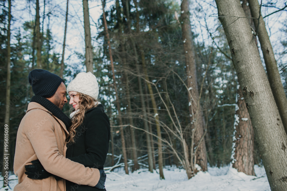 Couple posing in winter forest Couple posing in winter forest