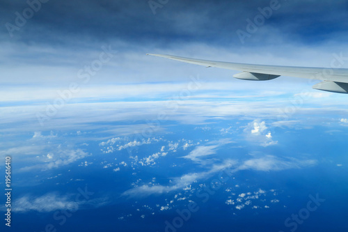 Aircraft wing above the clouds, view from the airplane window