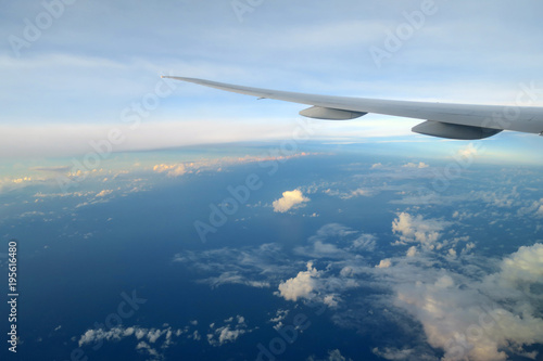 Aircraft wing above the clouds in sunset light