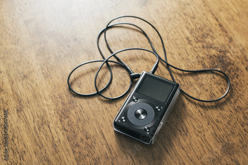 Music mp3 player on a wooden desk photo